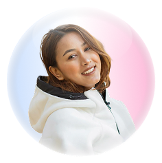 Chat Roshani shrestha with white jacket looking into camera smilling with gradient background